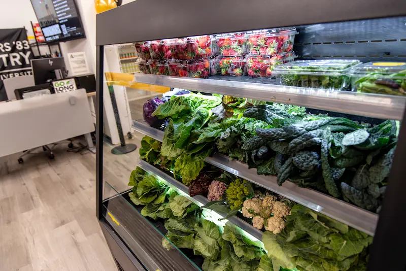 leafy produce in open refrigerator
