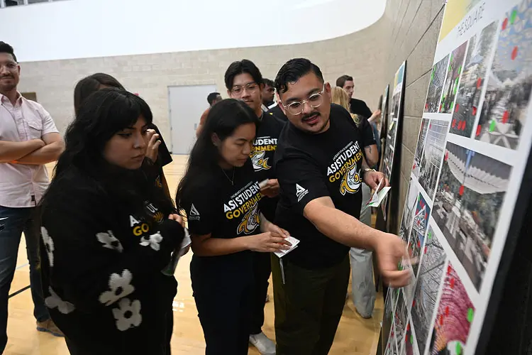 students looking at poster at Future U Validation Meeting