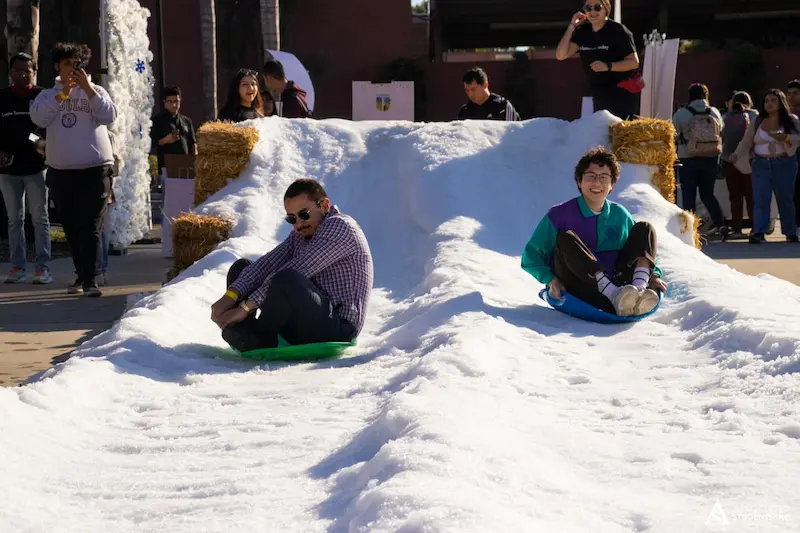 students sleding on fake snow