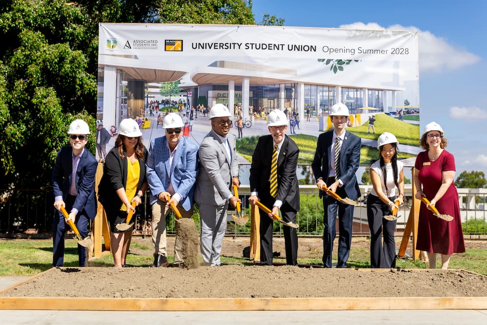 Students administrators and construction team groundbreaking