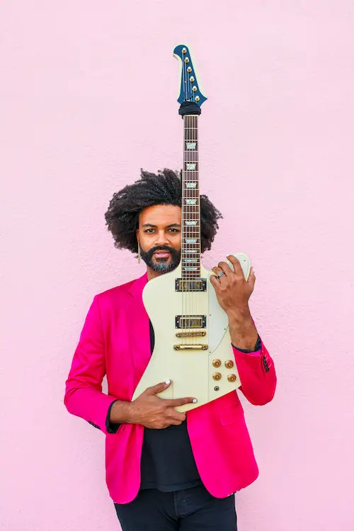 Reverend Doctor holding guitar